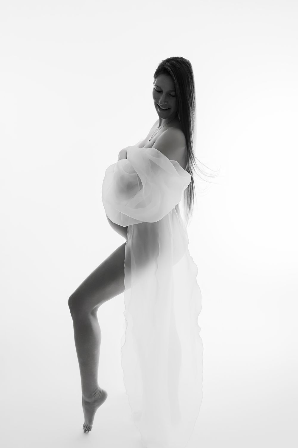 Artistic black and white photo series showing ethereal silhouettes of a figure in flowing white fabric against light background.