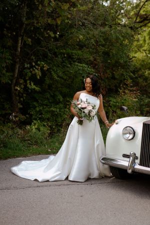 Bride standing by Rolls Royce. Samantha Bateman wedding photography.