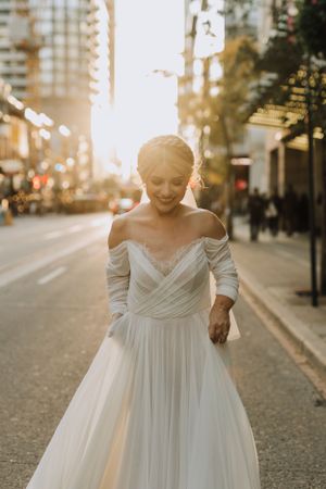 Bride walking down city street. Wedding photography by Samantha Bateman.