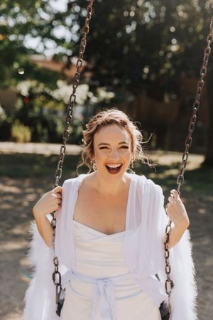 Bride on the swingset. Wedding photography by Samantha Bateman.