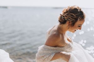 Bride walking by the lake. Wedding photography by Samantha Bateman.