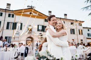 A dancing couple celebrates at their outdoor Italian villa wedding reception.