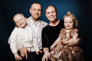 Studio family portrait with dramatic blue lighting.