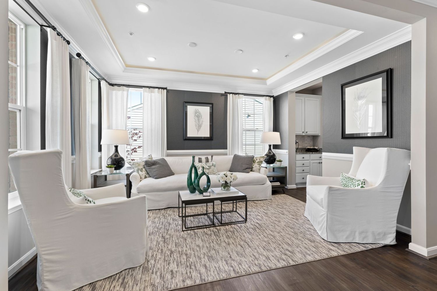 Contemporary open concept basement with light gray walls and wood-look flooring.