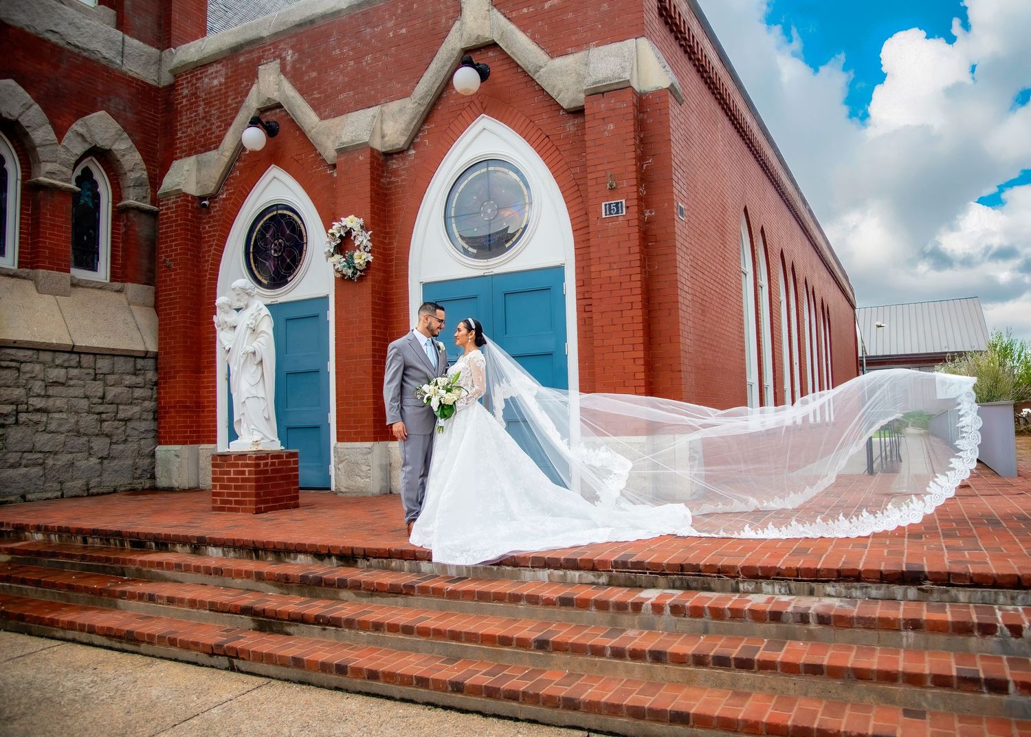 Wedding photos at a charming white chapel with gothic windows and architectural details.