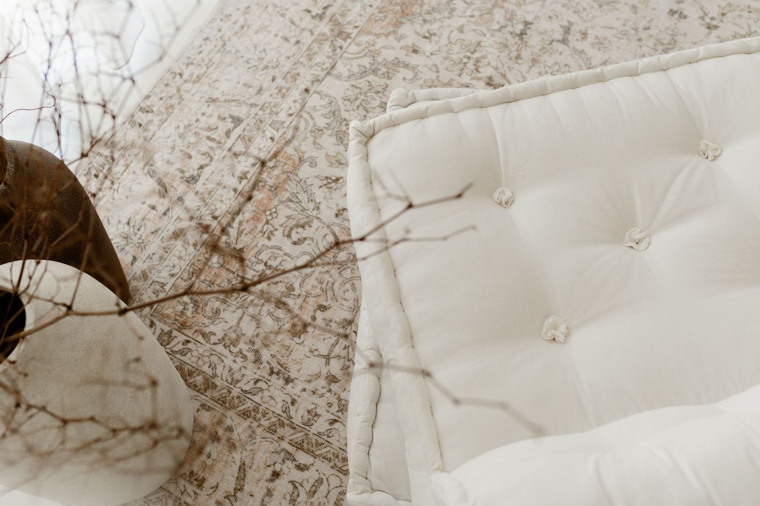 Minimalist white bedroom with woven basket on crisp bedding.