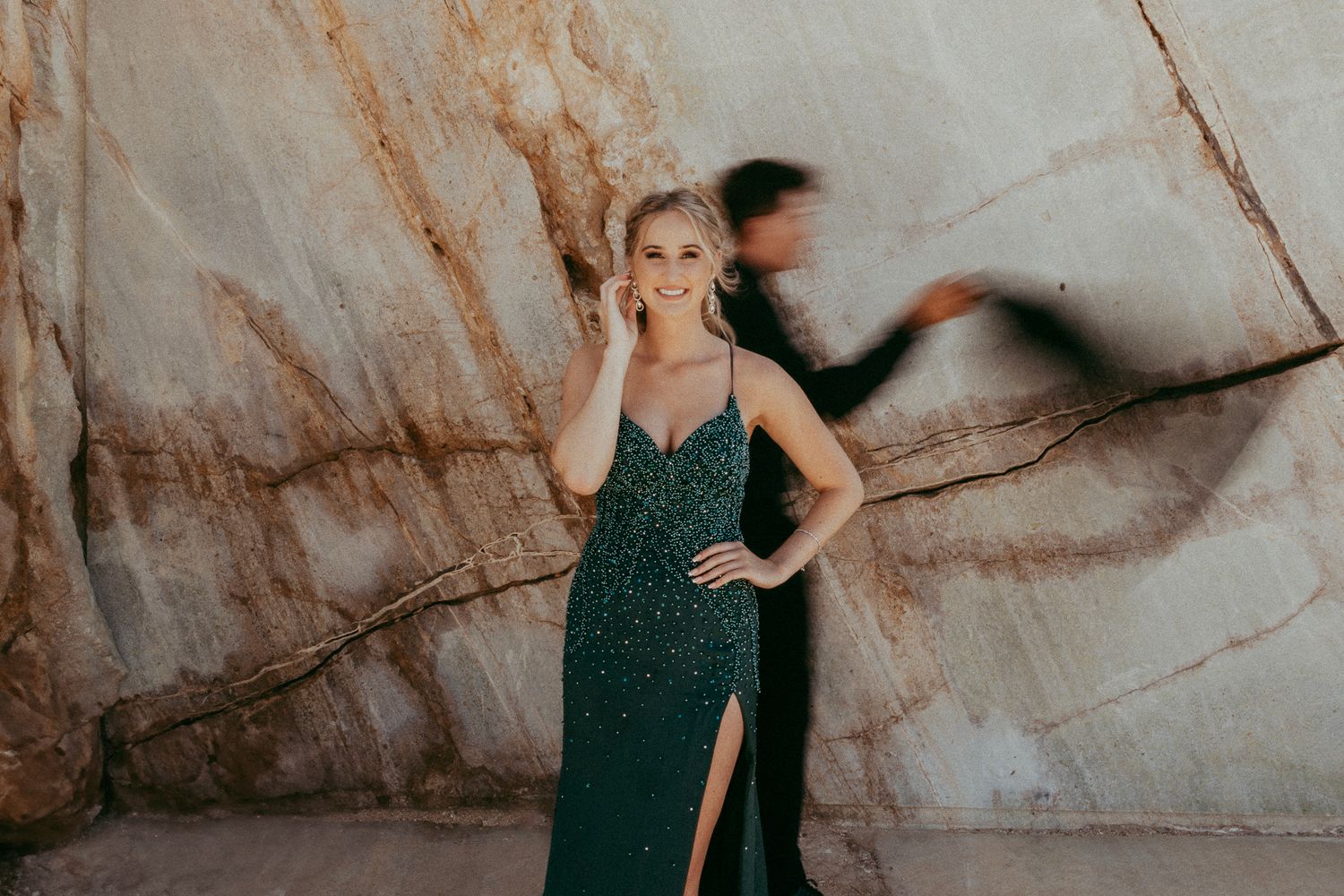 A stylish matric farewell photoshoot capturing a young couple dressed in elegant formal attire, posing with a scenic backdrop