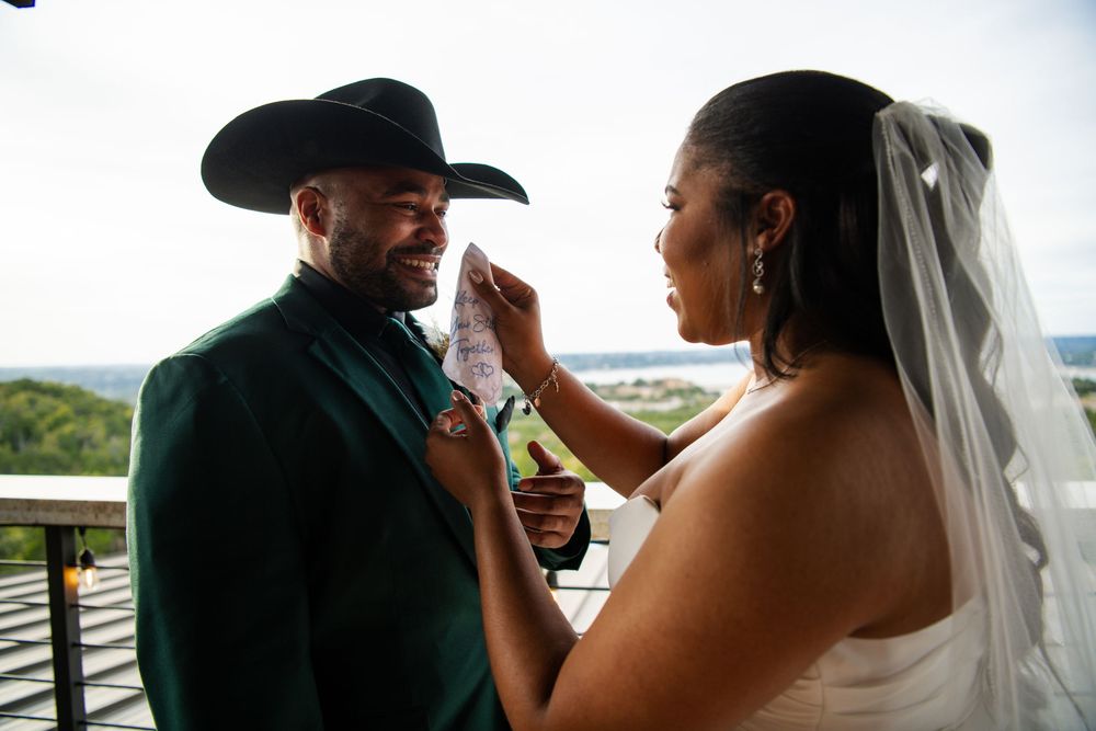 Intimate wedding moment captured on a balcony with scenic mountain views.