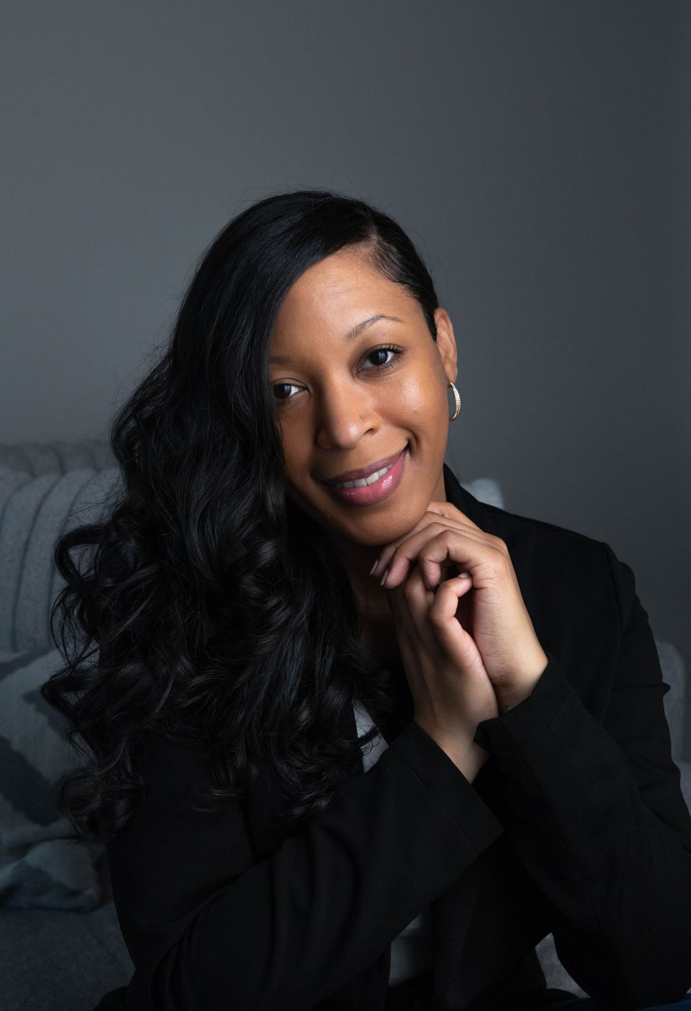 Dramatic studio portrait series with black blazer against dark background.  L Visions Photography.