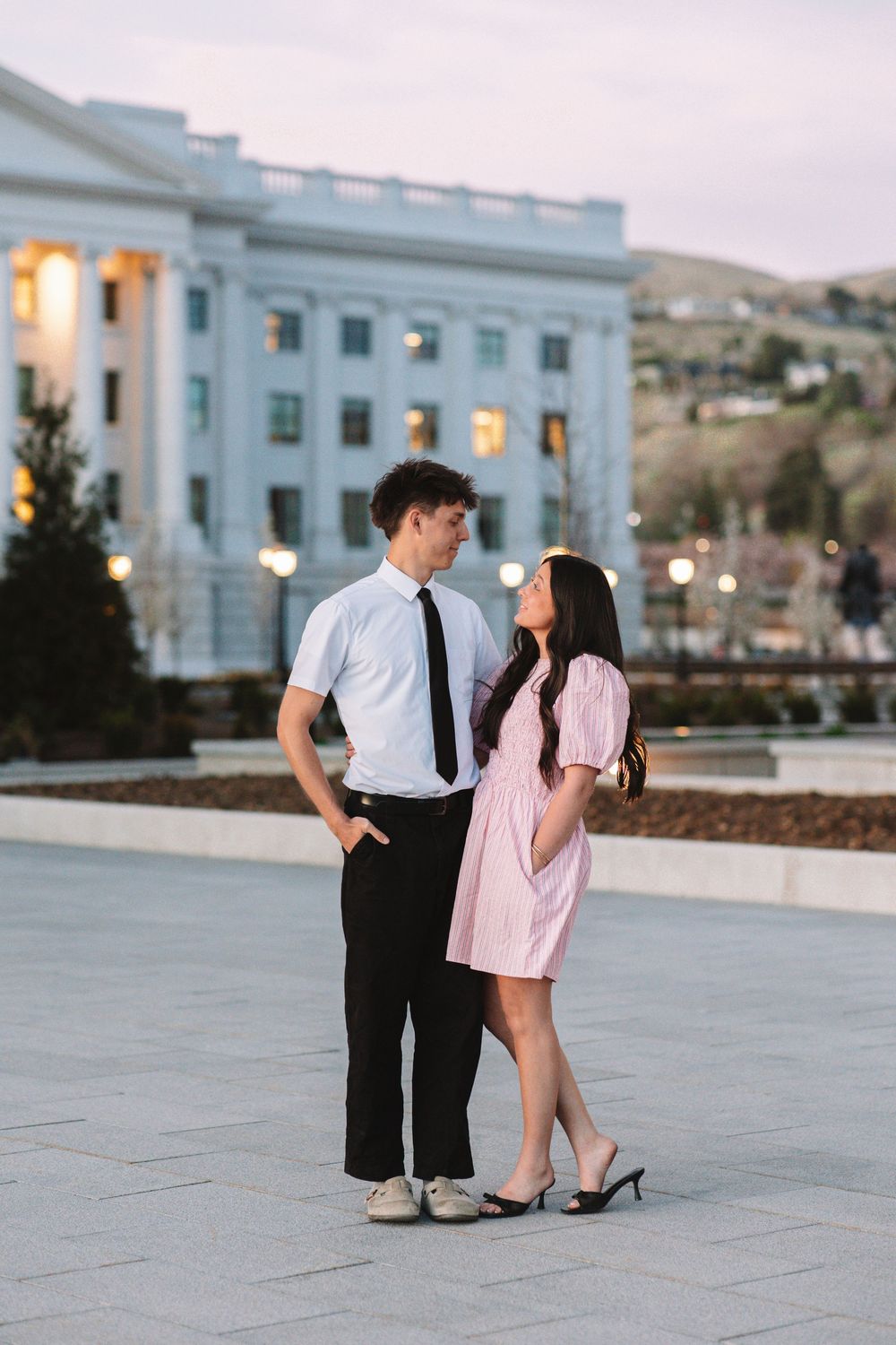 Couple posing for couples photoshoot at the Utah State Capitol Building.