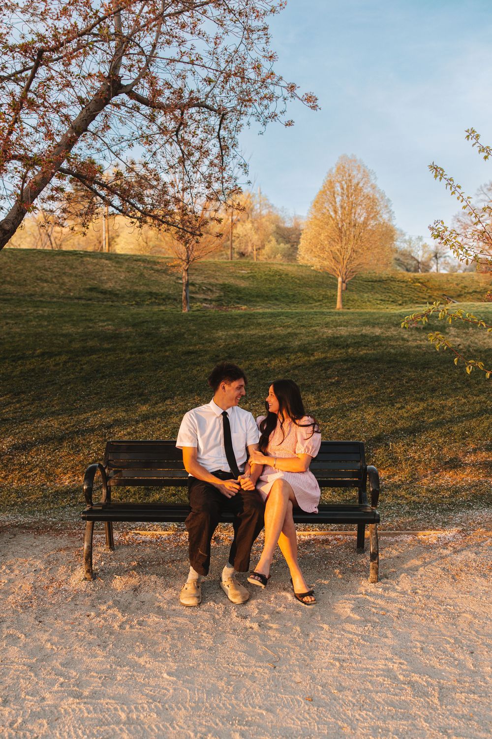 Couple posing for couples photoshoot at the Utah State Capitol Building during cherry blossom season.