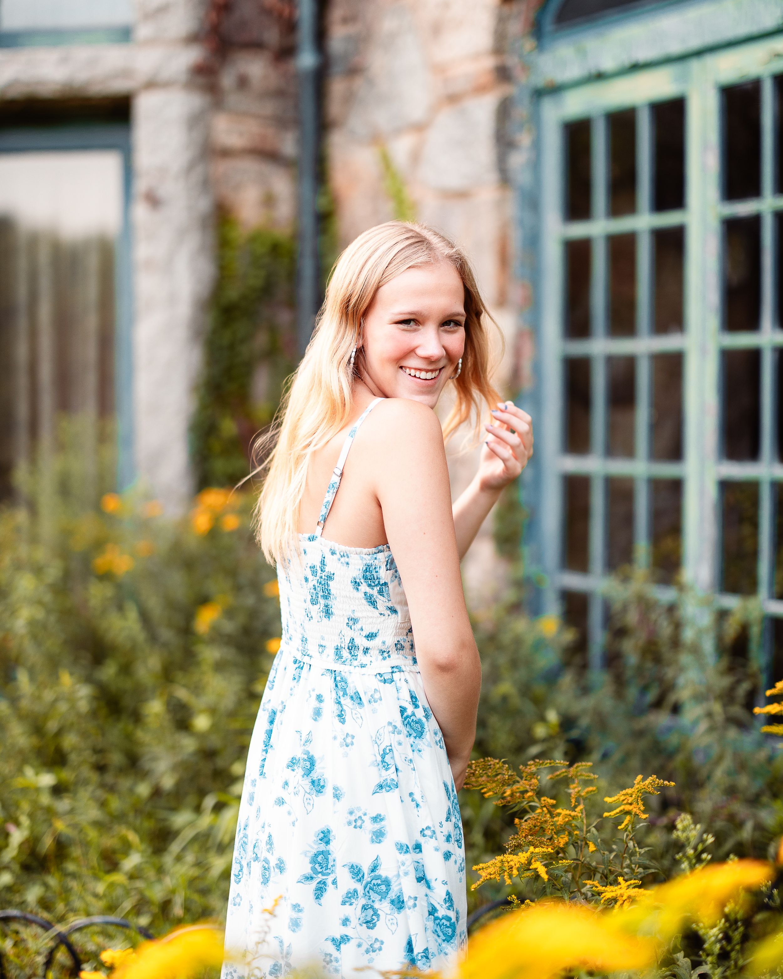 A King Phillip Regional High School senior laughs as she poses for her senior photos at Borderland State Park