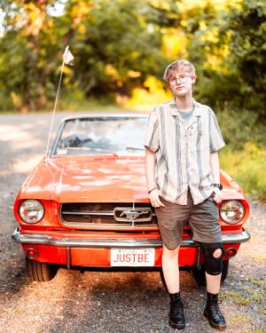 Southeastern Regional Vocational Technical High School senior posing with an old red car