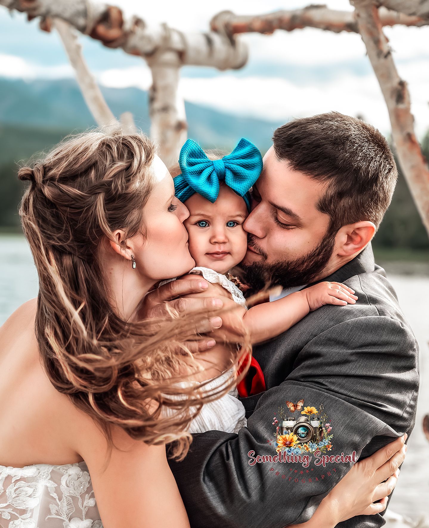 Family sharing a tender moment against a mountain backdrop.