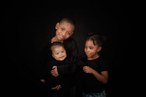Six black and white photos showing siblings in matching outfits posing together against a dark background.