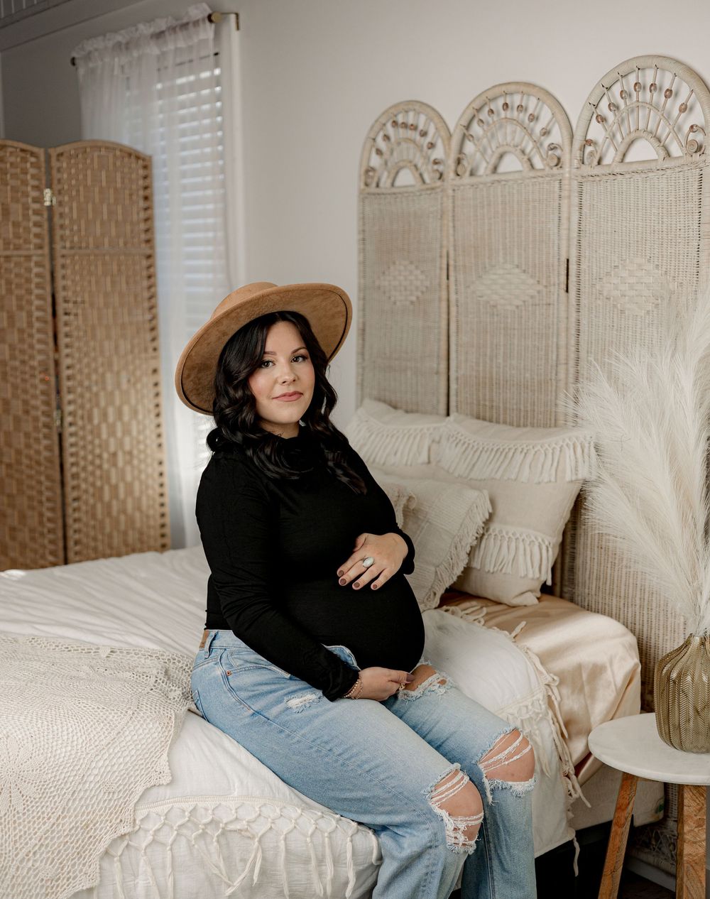 Cozy boho bedroom interior with folding screens, white bedding, and natural lighting creating a serene atmosphere.
