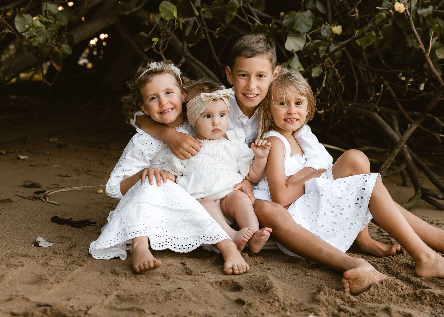 Mother and daughter in white outfits cuddling during a family photo shoot in Brisbane