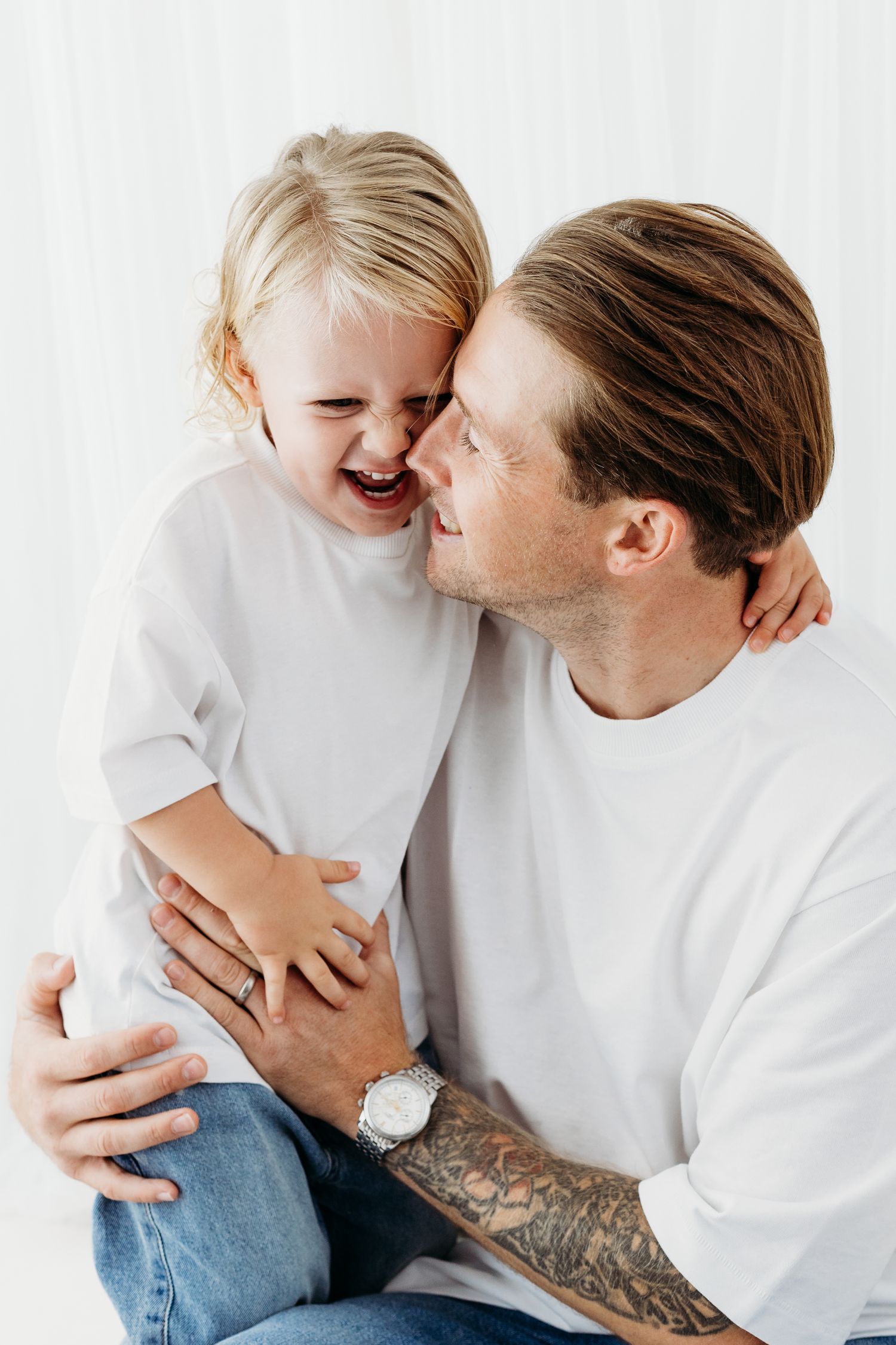 Nottingham family photographer capturing natural portraits of parents and children in calm, neutral Mapperley studio setting.
