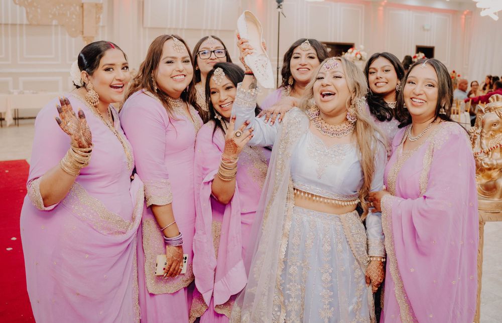 Wedding party in coordinated pink outfits celebrating during reception.