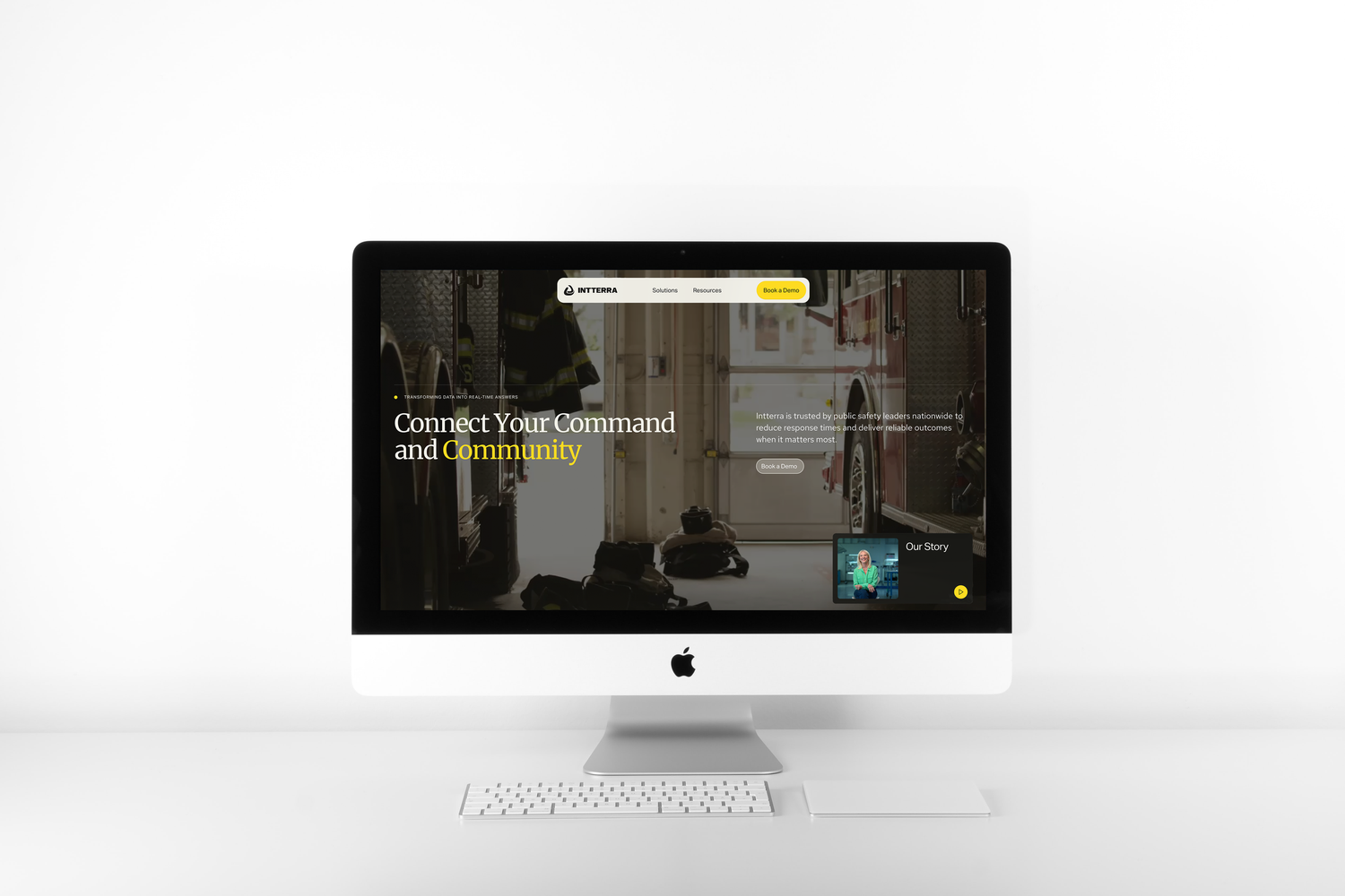 Modern iMac desktop setup displaying a minimalist website homepage on white desk.