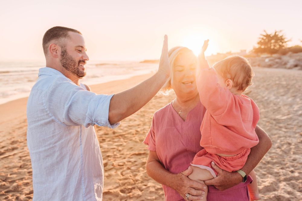 Candid moments of family laughter and joy during sunset beach photography session.
