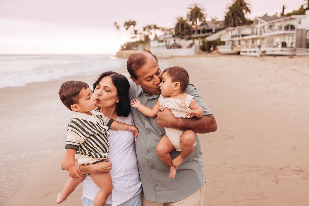 Candid family moments captured during sunset at a scenic beachfront location.