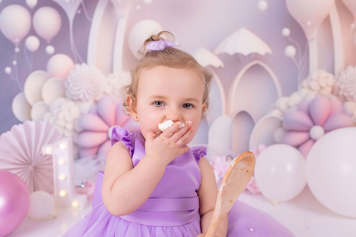 First birthday setup with blue balloons and white ONE blocks for baby photo session.