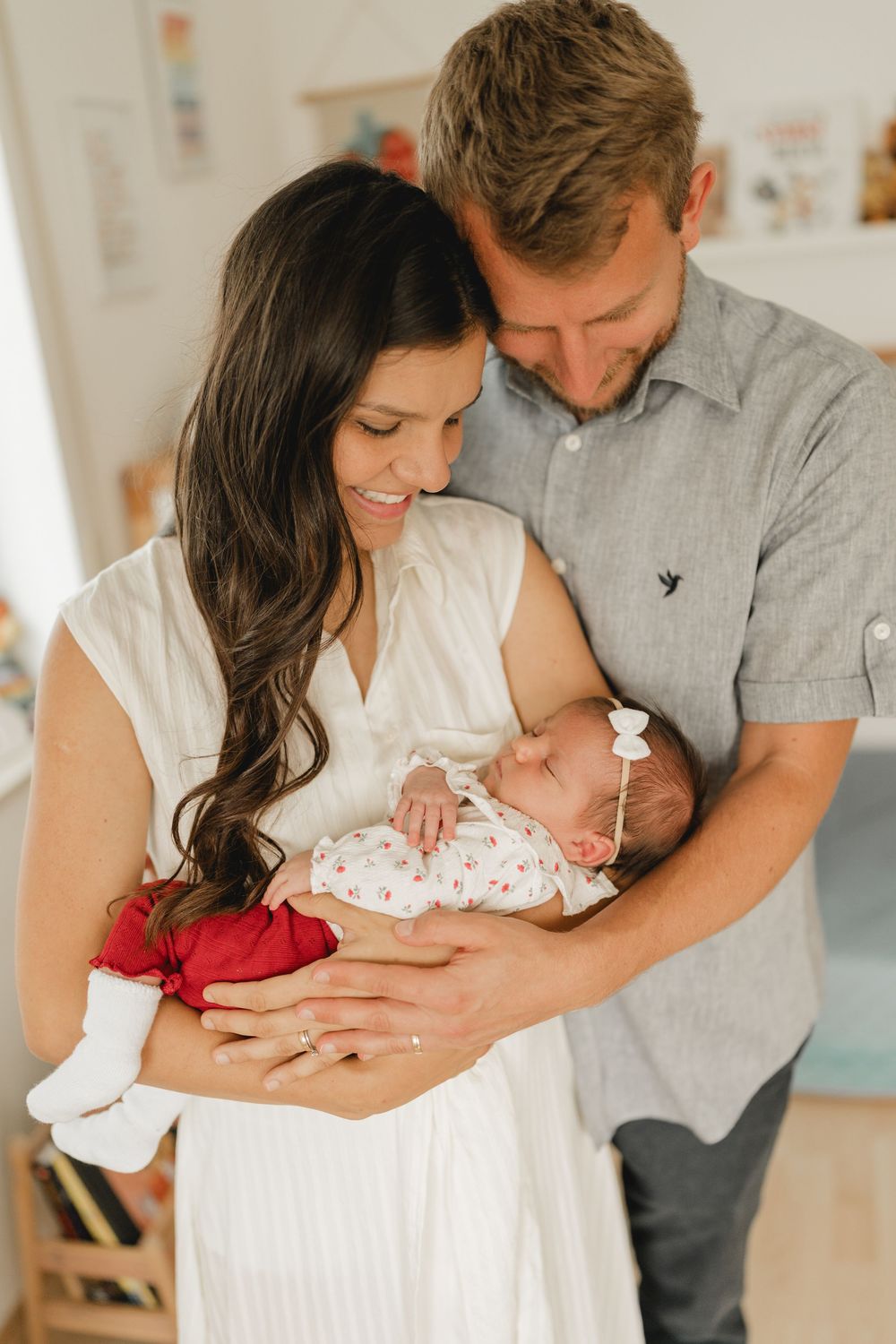 Eltern mit neugeborenen Baby auf dem Arm - Liebevolle Babyfotografie im eigenen Zuhause in Biberach von Ramona Maier