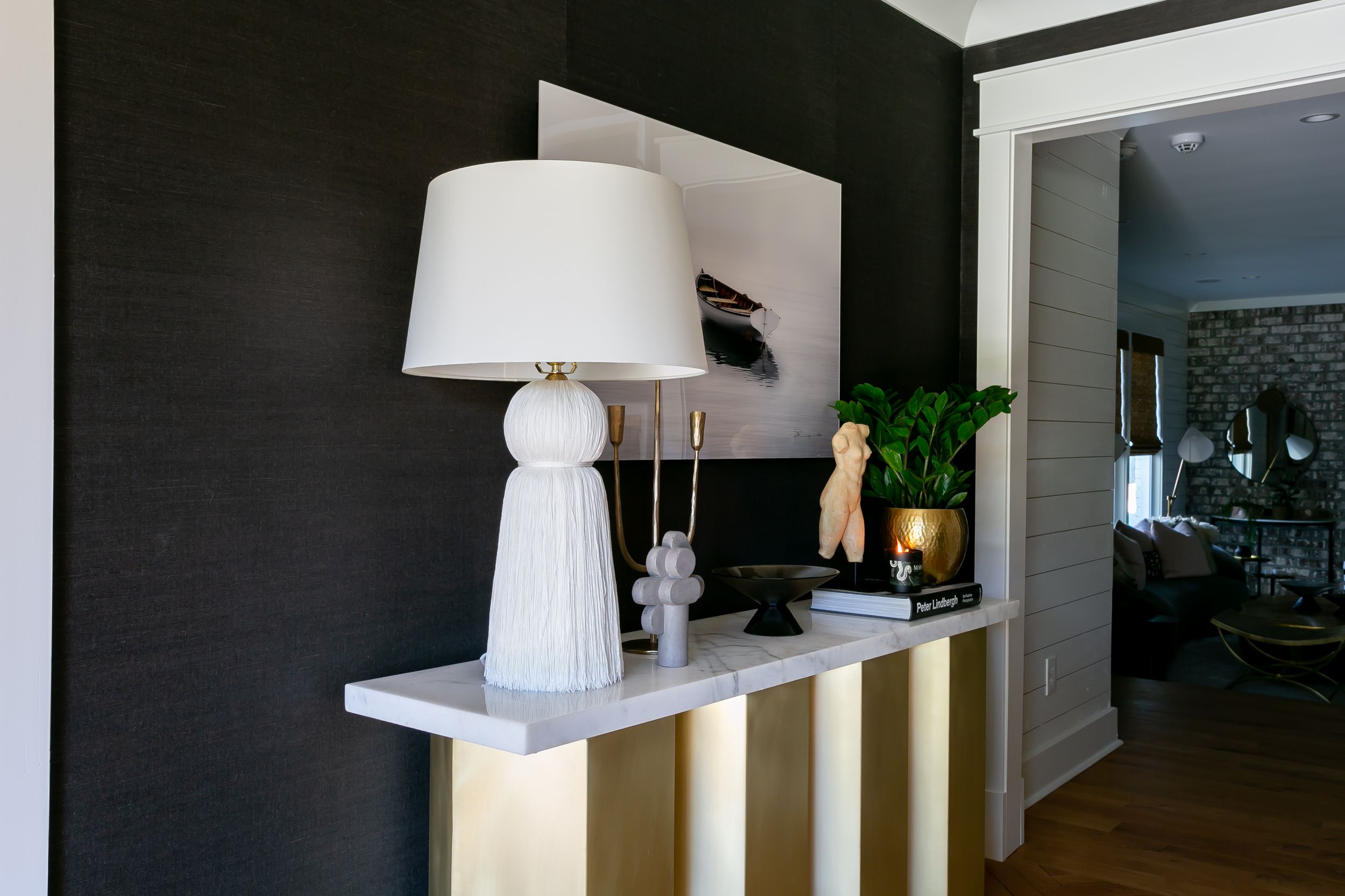 Modern minimalist interior with black accent walls and white furniture.