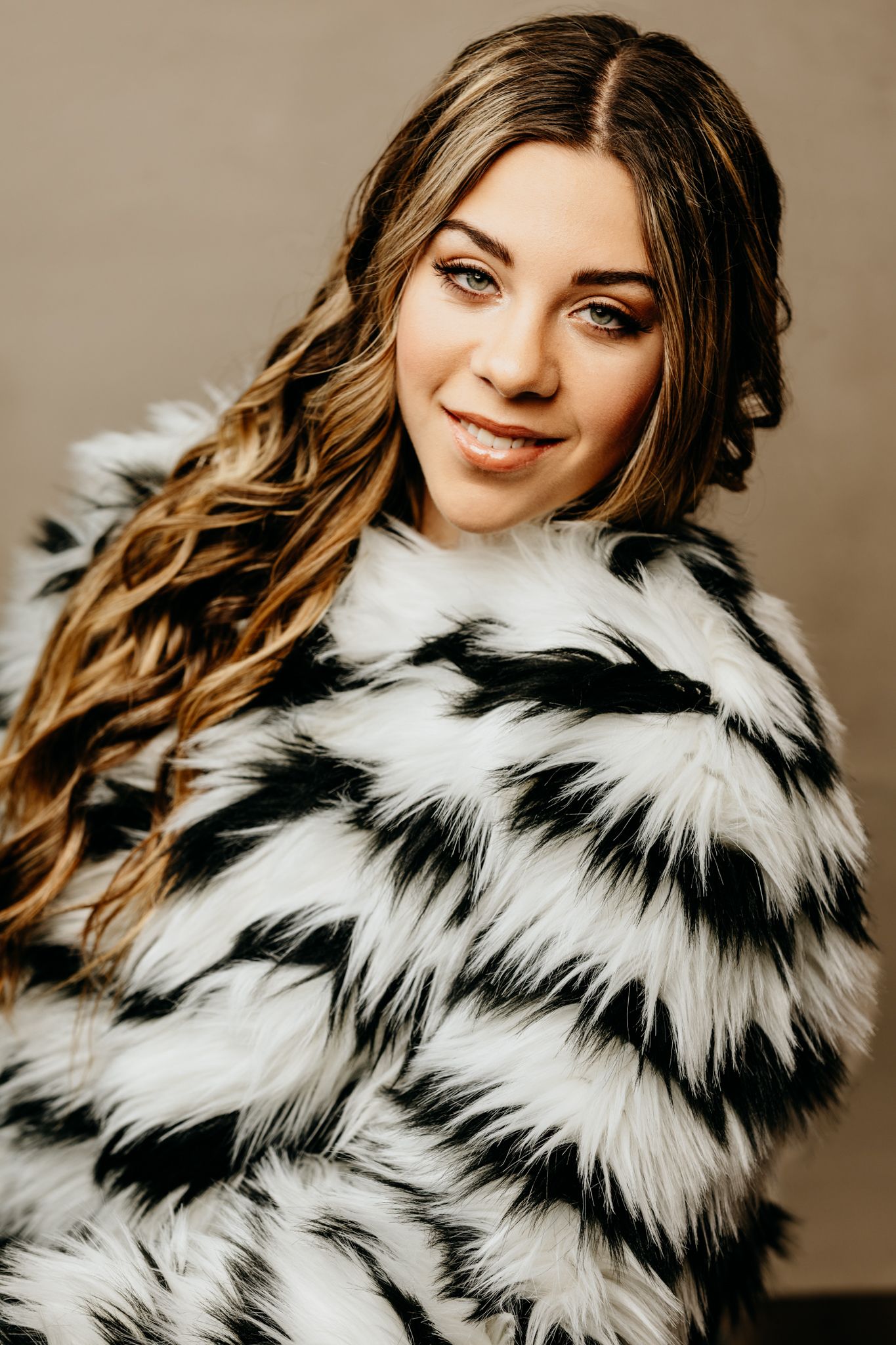 Black and white fur coat fashion detail shot with dramatic styling.