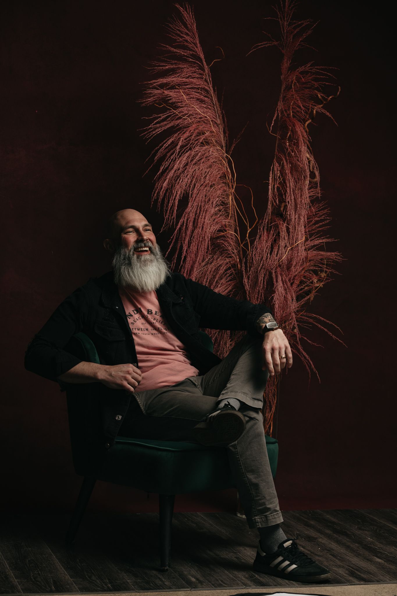 Dramatic black and white portrait series featuring a bearded figure against a dark background with red lighting.