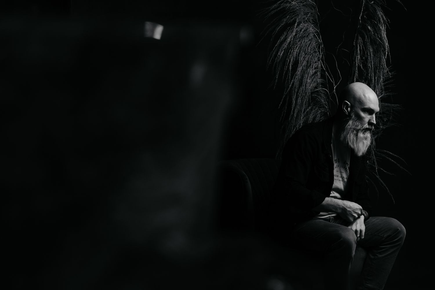 Dark minimalist portrait series emphasizing silhouette and form against black background.