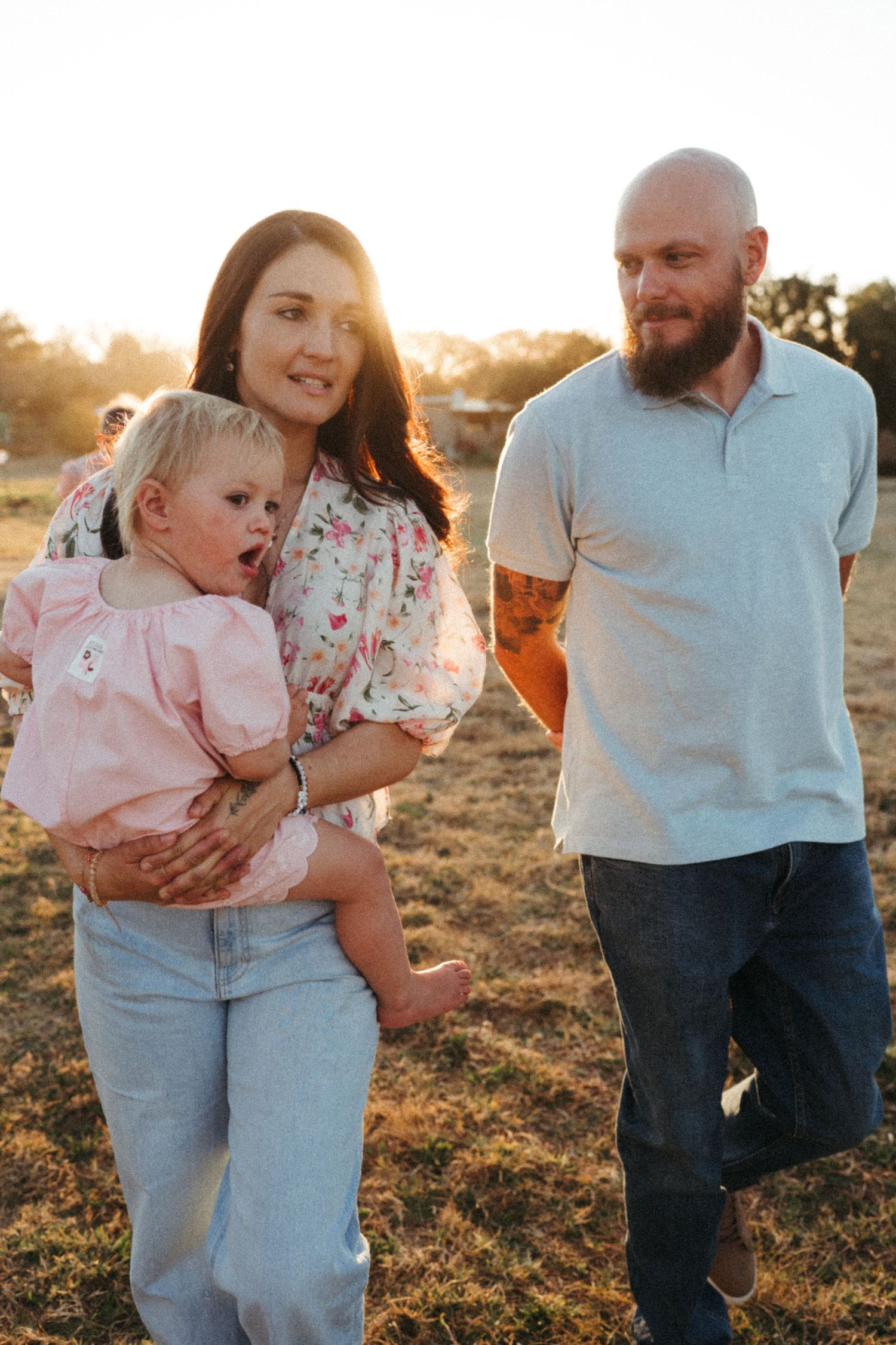 A family enjoying quality time together outdoors during golden hour.