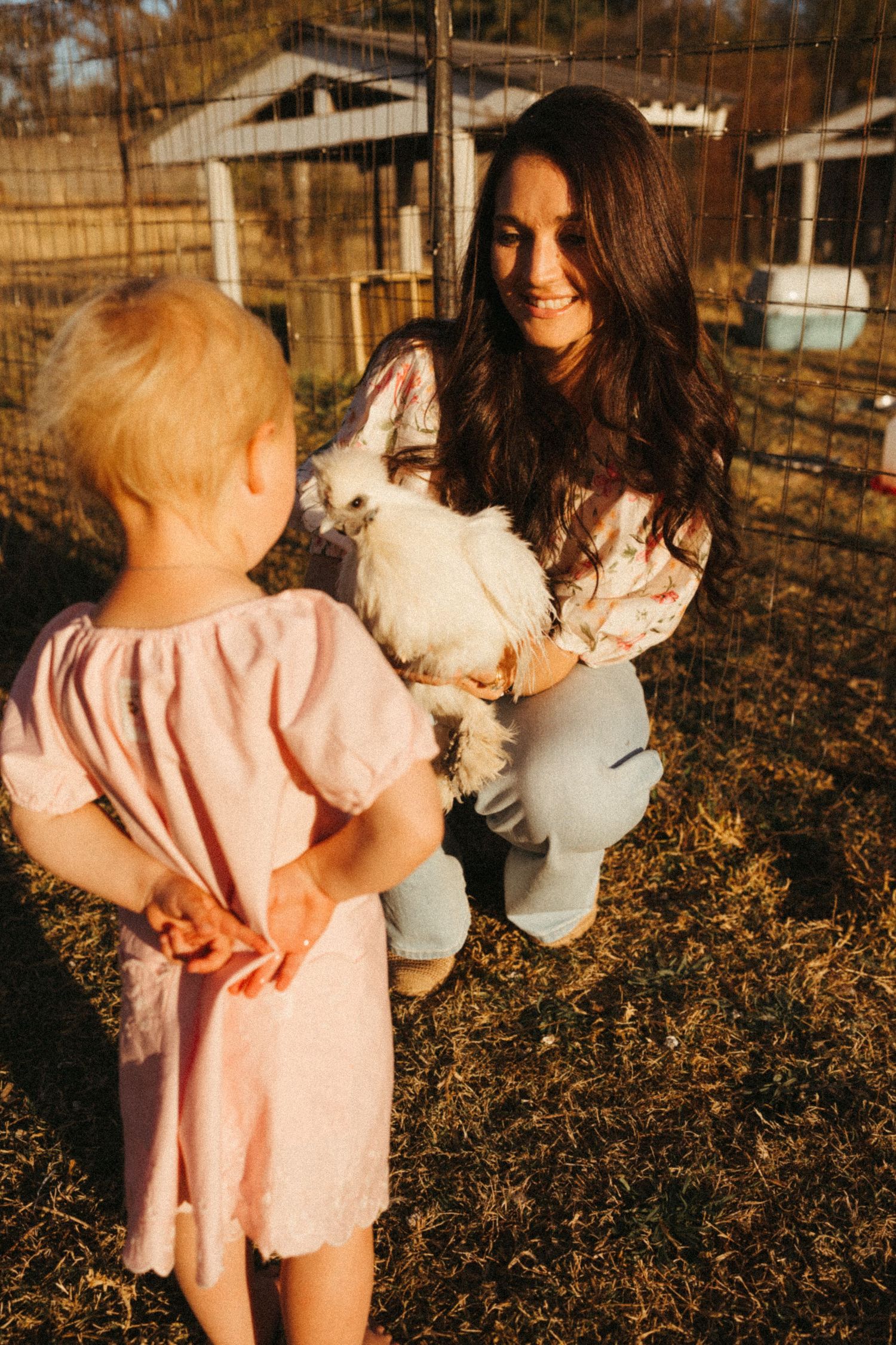 Two people share a tender moment in an autumn farm setting.