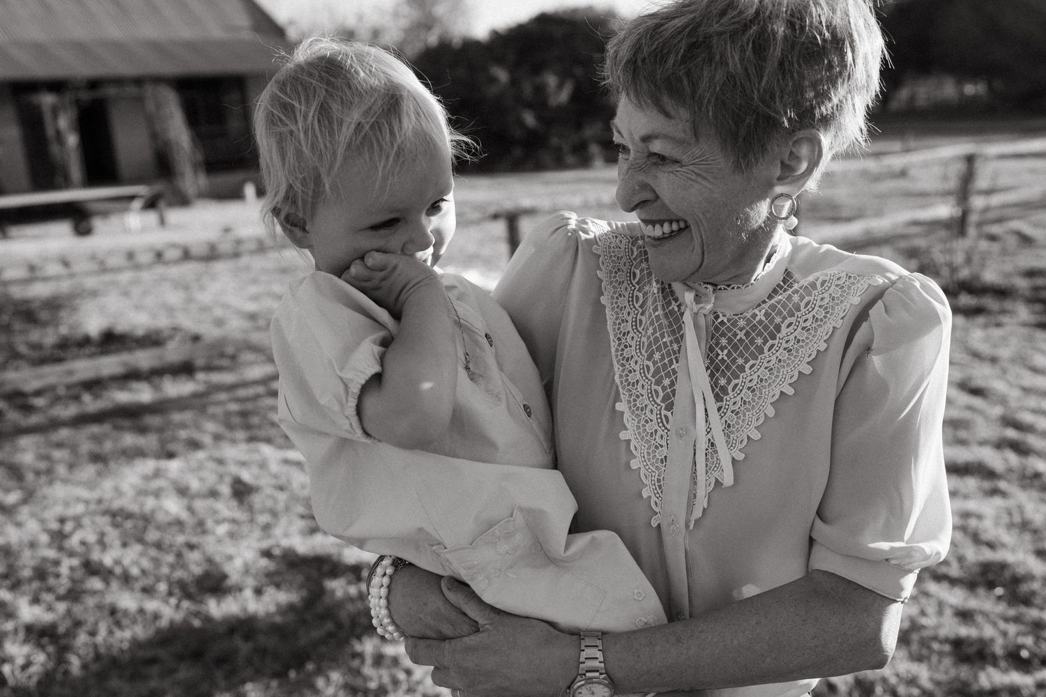 Black and white portrait of tender family moments outdoors.