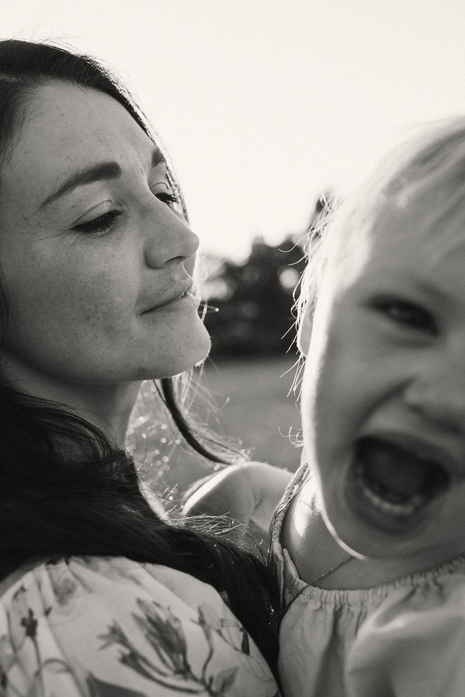 Black and white portrait capturing joyful laughter and intimate family connection.