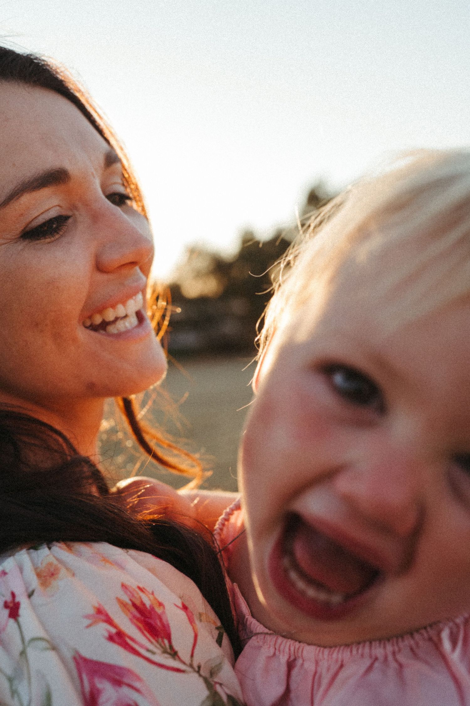 Candid close-up shots of pure joy and laughter during a sunset family photo session.