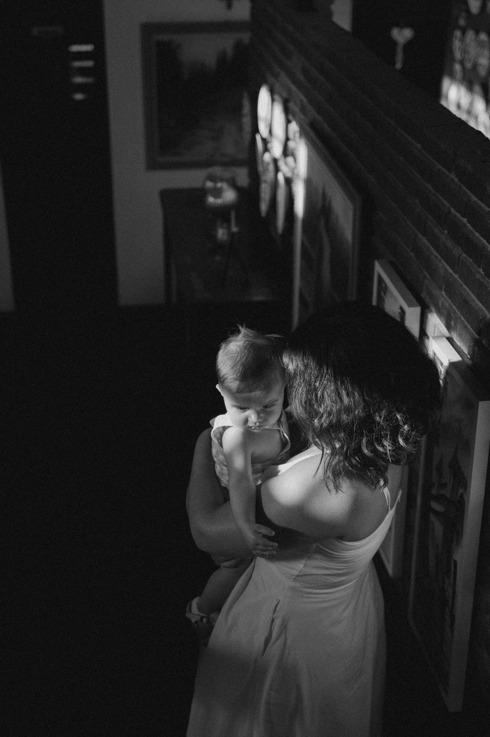A romantic black and white photo series showing an intimate couple's embrace in low light.