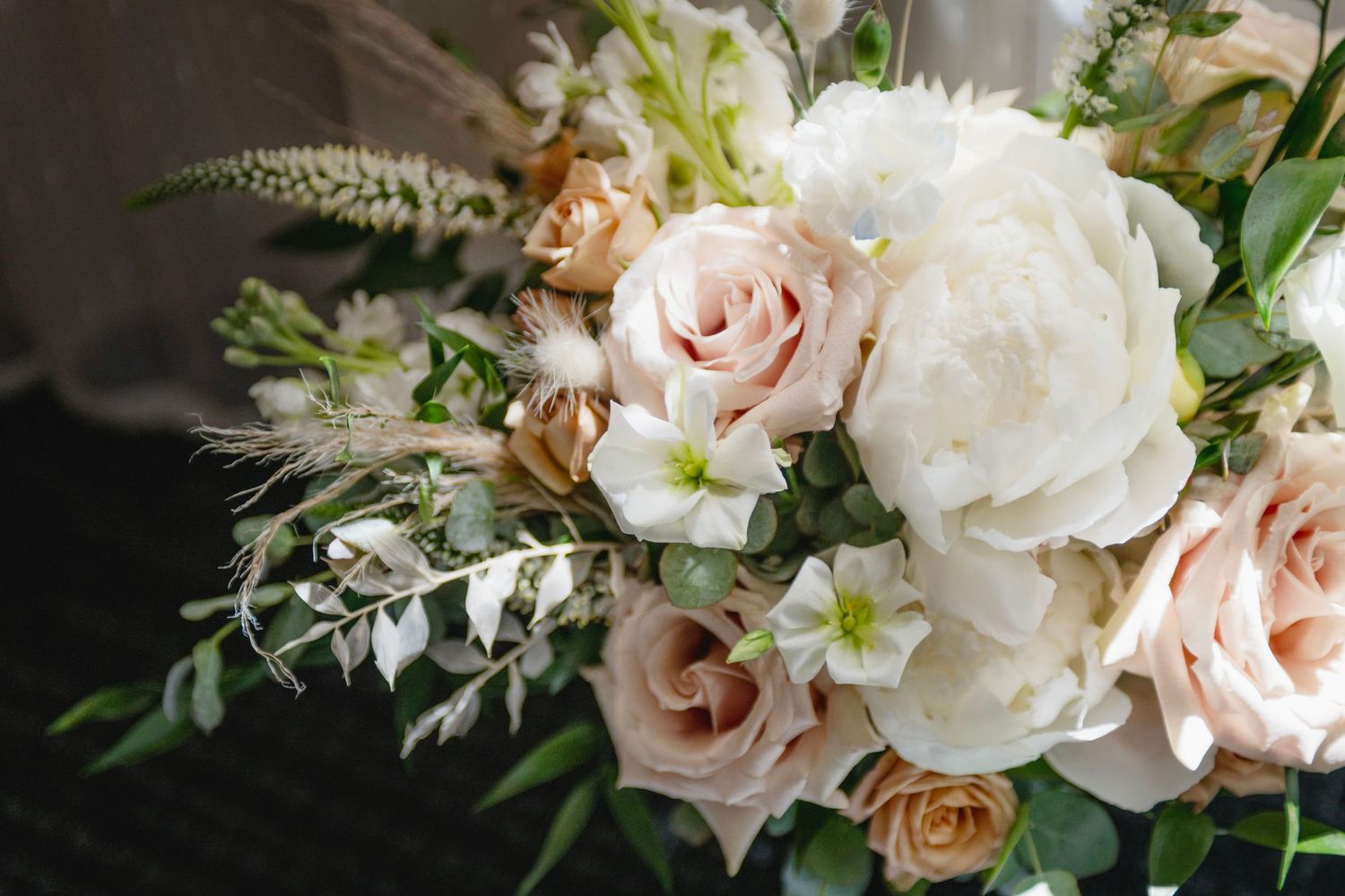 beautiful bouquet of wedding flowers, dramatic lighting. Editorial feel. Floral arrangement. Wedding detail shots.