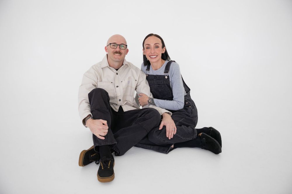Four progressive images show two people sitting and posing together against a white background.