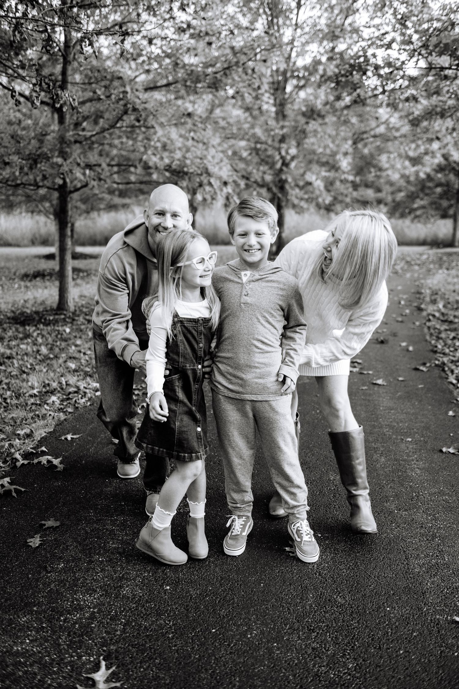 Multi-generational family gathering outdoors captured in black and white photography.