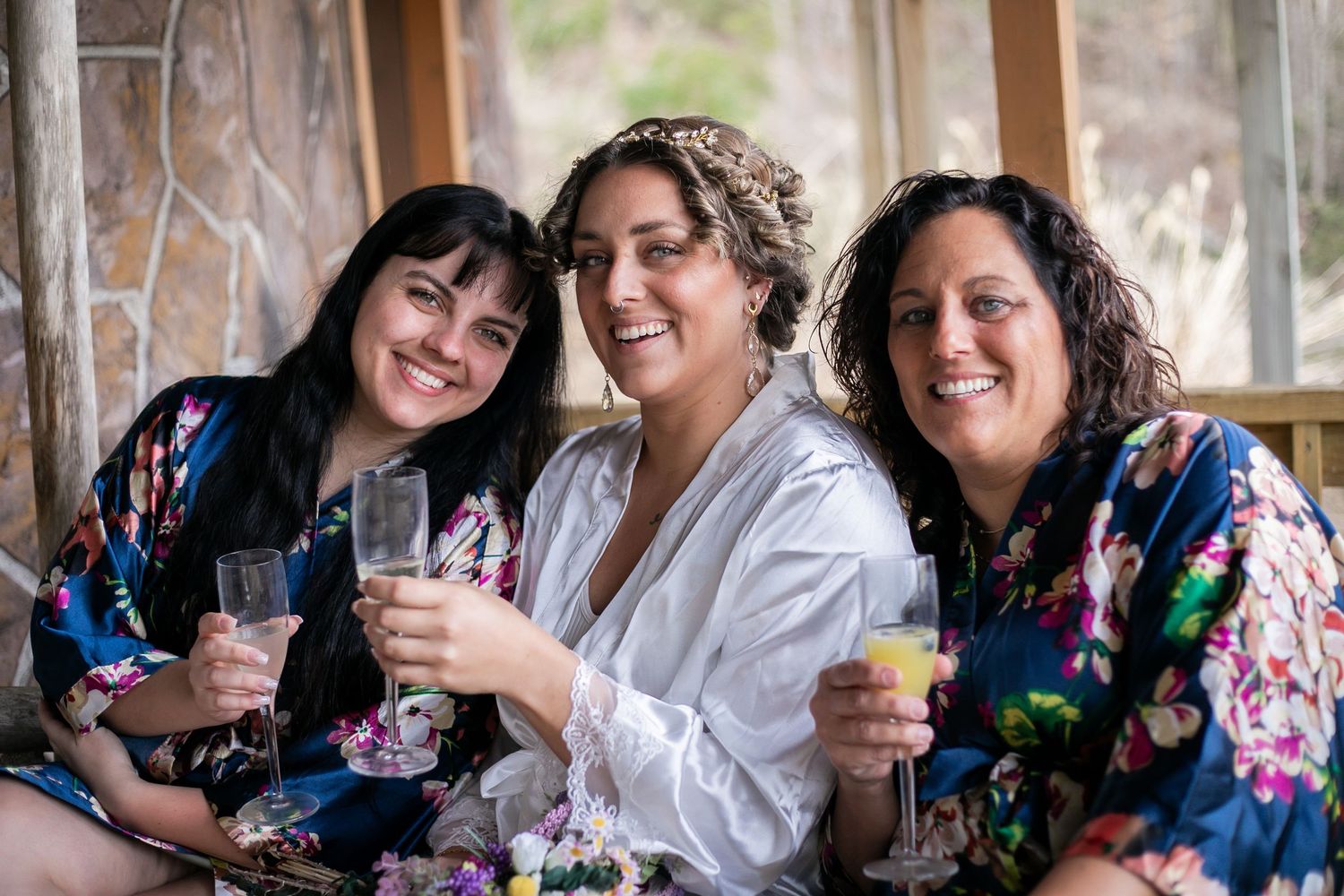 A group shares laughter and joyful moments together while sitting at a table decorated with floral arrangements.