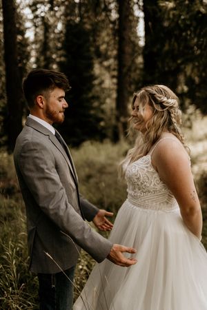 Couple shares intimate moments during their forest wedding photoshoot.