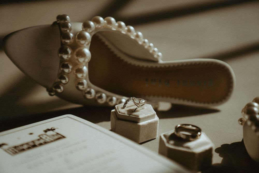 Wedding accessories including pearls and jewelry arranged in soft lighting.