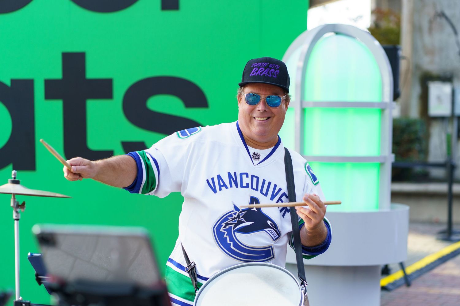 Vancouver Canucks hockey fans celebrate and cheer while wearing team jerseys at Rogers Arena.