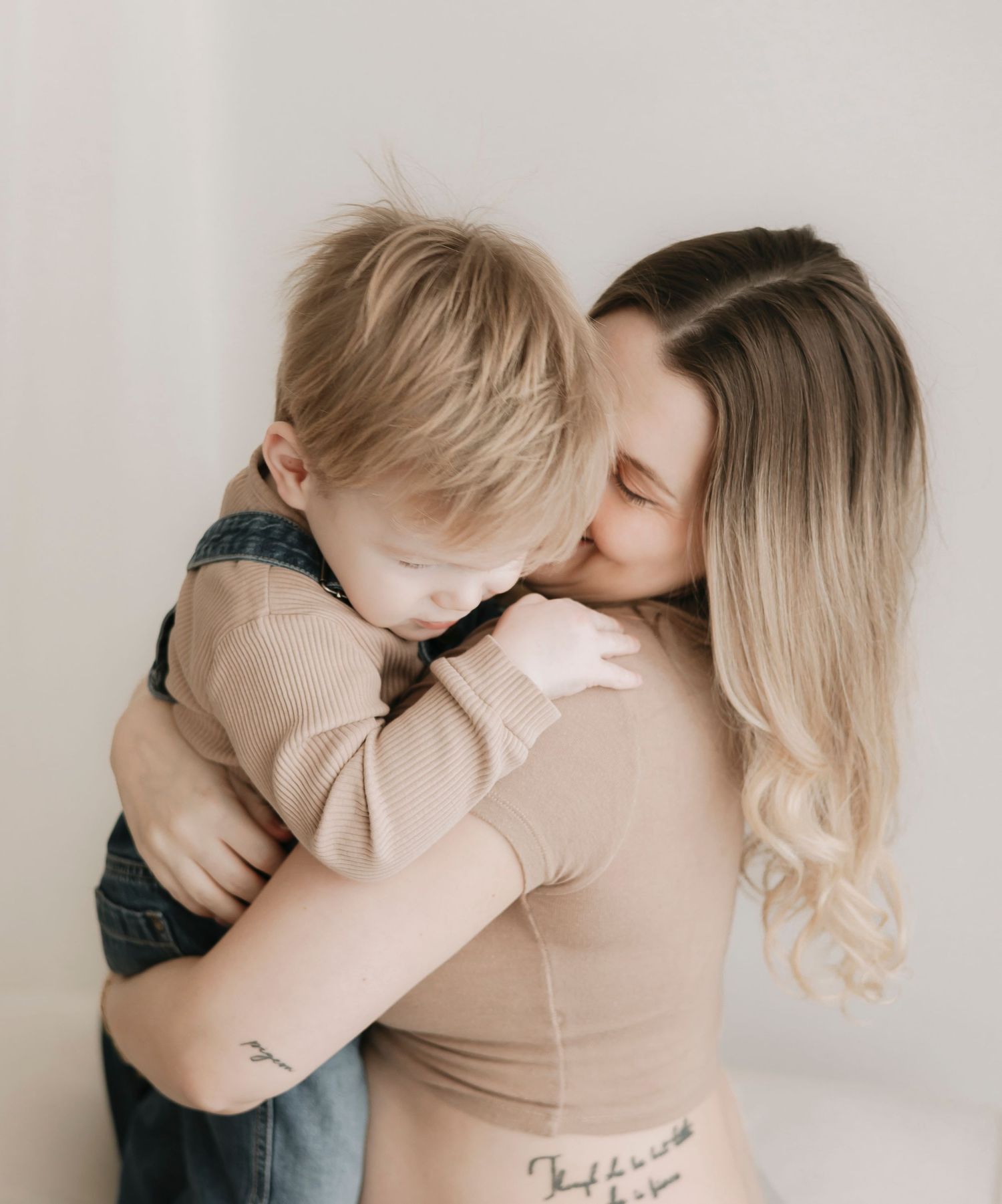 A tender moment captured in black and white showing affectionate embraces between parent and child.
