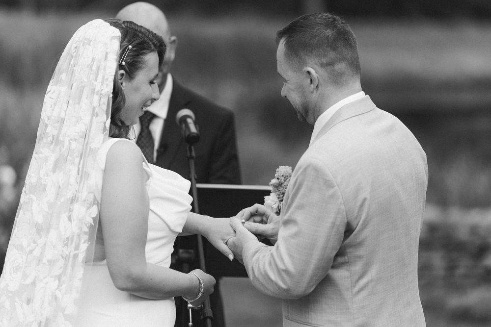 A black and white photo collage showing multiple wedding moments with couples dancing and celebrating together.