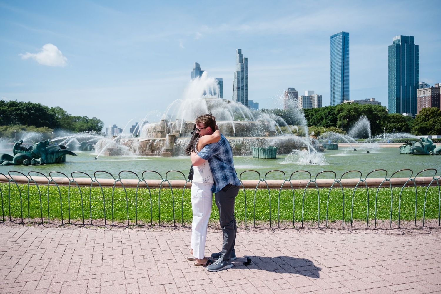 Buckingham Fountain sprays water against the Chicago skyline on a sunny summer day at Grant Park.
