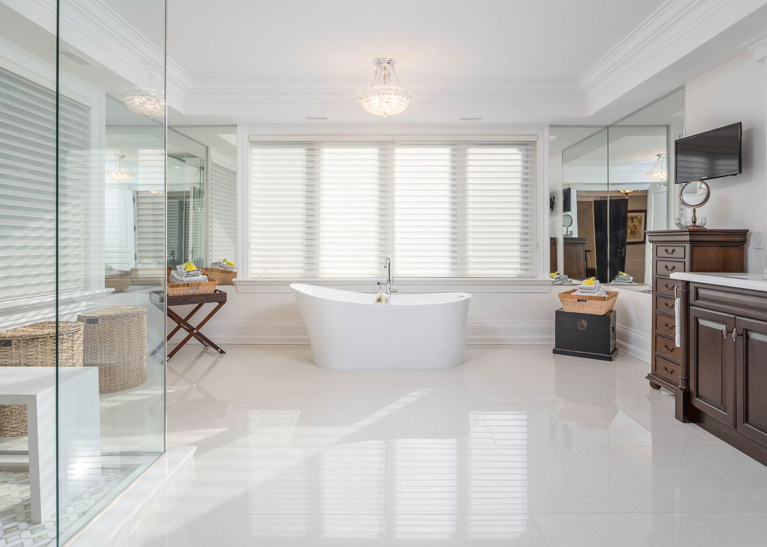 Bright white modern interior with glass partitions and natural light streaming through windows.