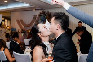 Bride and groom sharing a kiss on the dance floor at their wedding reception.